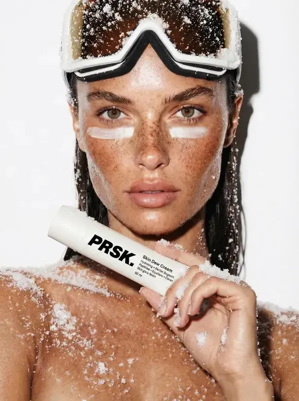 Video frame of a skincare campaign with a model in snow goggles