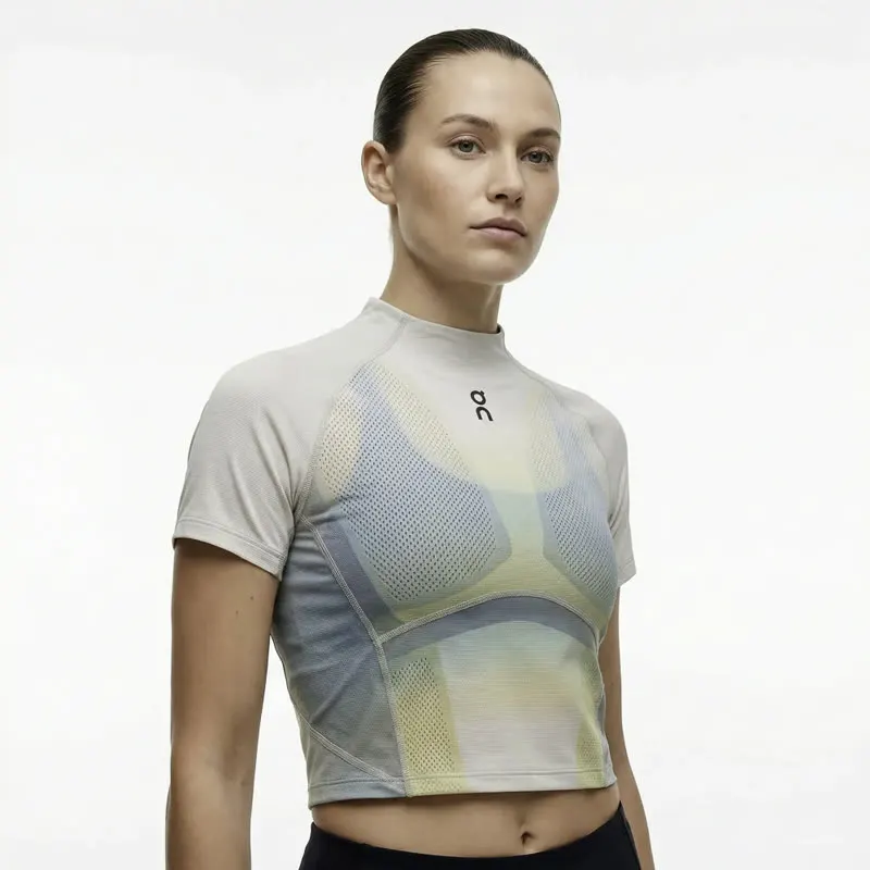 Model wearing a cropped athletic top with gradient print